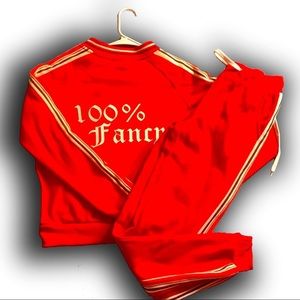 A hot red jogging set with pants white & black stripes on the side